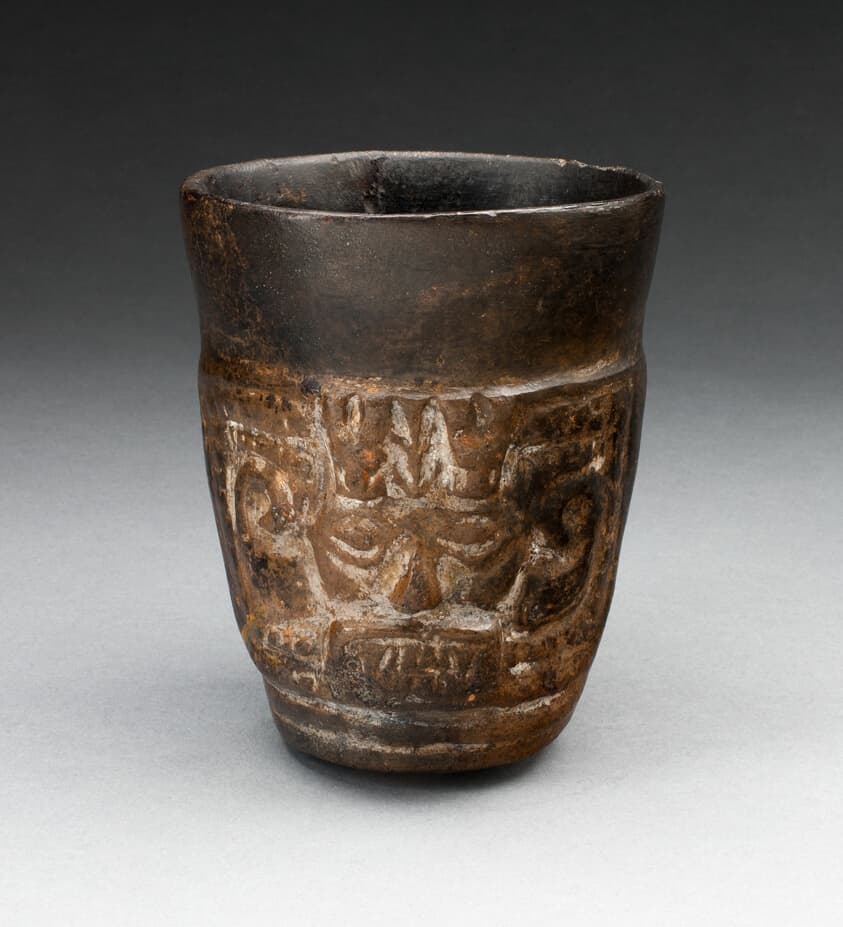 Blackware Cup with Abstract Faces Carved in Panels